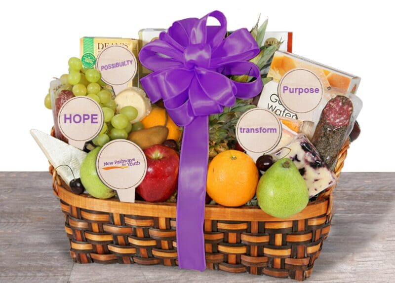 New Pathways for Youth fundraising gift basket with fresh fruit, gourmet treats, and inspirational tags highlighting hope, purpose, and possibility.