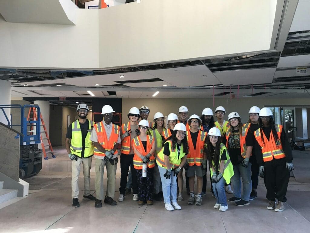 Participants visit a DPR Construction job site, touring a building under construction while learning about careers in the construction industry.