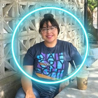 New Pathways for Youth | Possibilities Circle A smiling man in casual attire with a neon blue circular frame effect highlighting his portrait.
