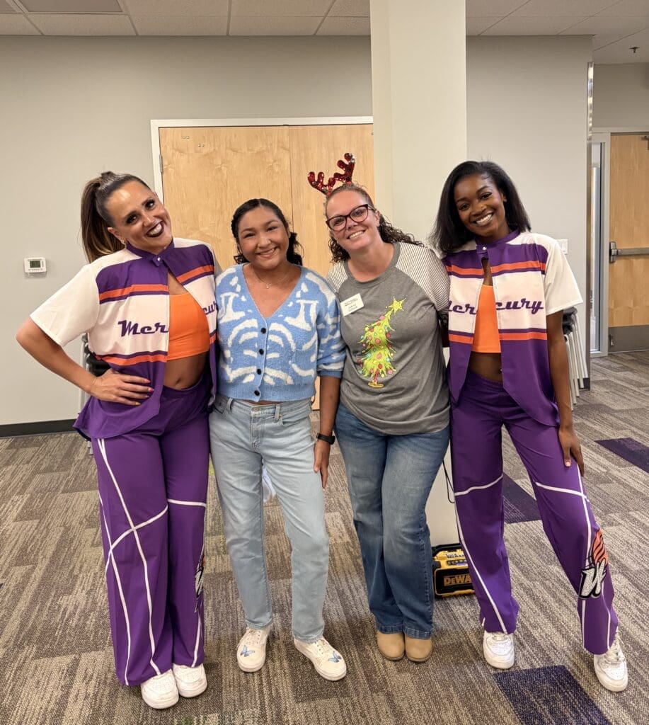Students with members of the Mercury Hip Hop Squad after a dance class at New Pathways for Youth